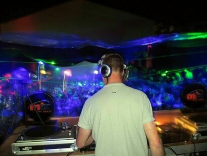 A DJ, playing music in a disco