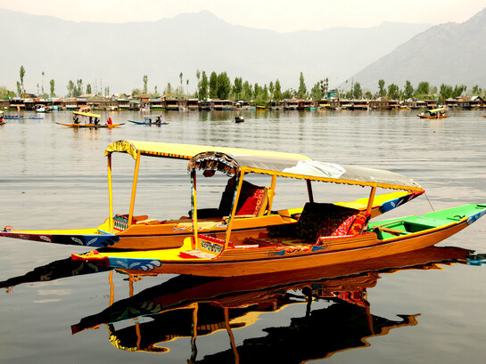 Colourful tour boats drifting across a peaceful lake in Shillong, Meghalaya, India