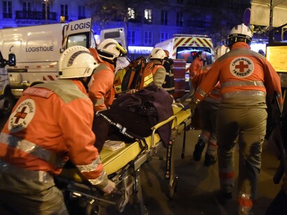 Red Cross workers evacuate another injured person near the Bataclan. Photograph: Dominique Faget/AFP/Getty Images