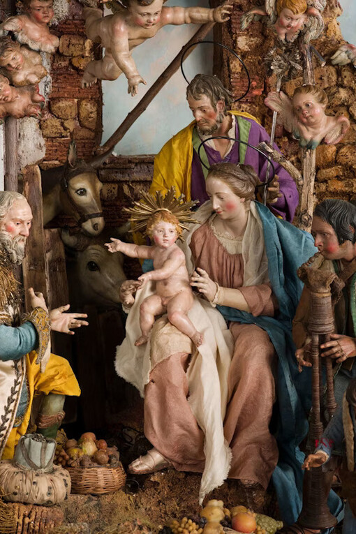 The Holy Family, At the center of the crèche, Mary holds the infant Jesus on her lap beneath a humble structure made of twigs and wooden fragments. Her spouse, Joseph, stands behind her in a yellow cloak. These three are the only characters wearing haloes and Classical draperies rather than contemporary Neapolitan dress. Courtesy of the Art Institute of Chicago