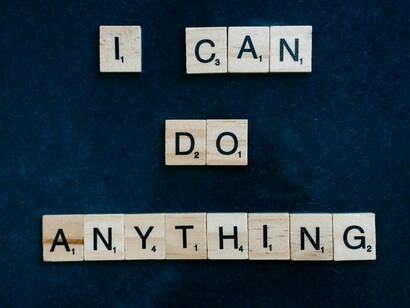 A positive affirmation showcased on a blue board, representing a healthier relationship with one’s thoughts