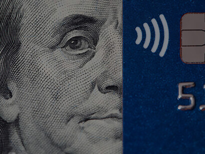 Debit card paired with a $100 bill, illustrating financial transactions and monetary value