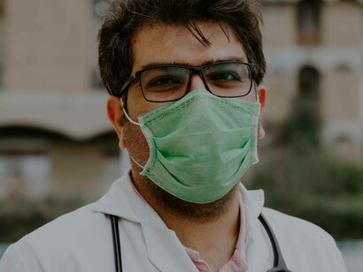 A doctor taking a break outside the hospital after dealing with numerous patients who have co-infections