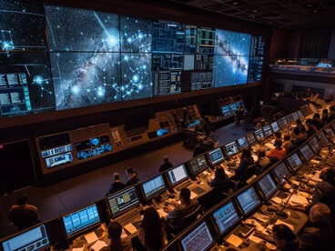 Mission control room showing human oversight of AI systems