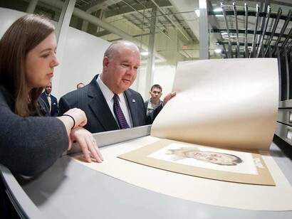 Art Curator Sarah Forgey explains to Under Secretary of the Army Joseph W. Westphal techniques implied to ensure the preservation of the Army's collection of delicate art on paper at the U.S. Army Center of Military History's Museum Support Center Facility, May 30, 2012