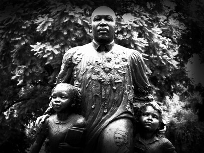 The statue on Riverside’s Peace Walk of Martin Luther King Jr. a leader of the civil rights movement for African Americans, with two children standing with him (California, USA)