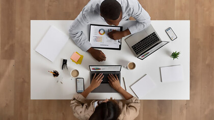 Two people with opposing personalities—an introvert and an extrovert—working together in an office, showcasing the power of collaboration and social interaction