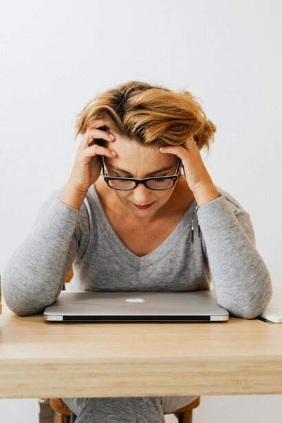 Woman in gray long sleeves and eyeglasses considering how regression to the mean can affect perceived OCD treatment outcomes