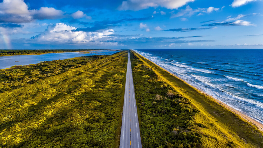 A road through Florida, with the ocean to one side and a body of water on the other