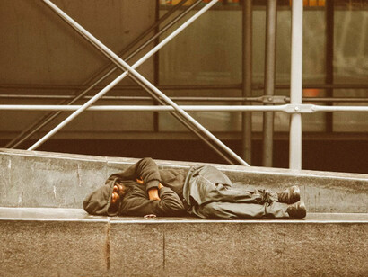 A person without a home sleeping on a city street