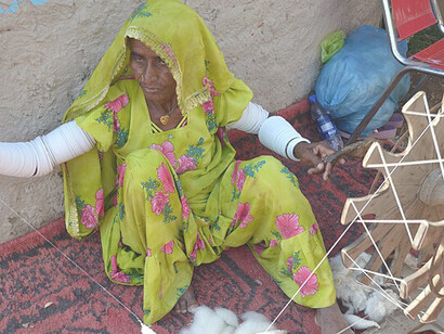 A Pakistani woman weaver working as a laborer