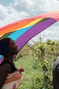 Members of the LGBTQ+ community marching with their flag in the Kakuma refugee camp in Kenya