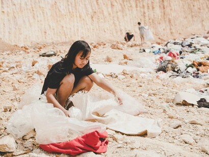 Three children forced into survival rummaging through garbage in the hopes of finding something they can sell