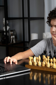 Pensive, a young chess player competes against a chess software