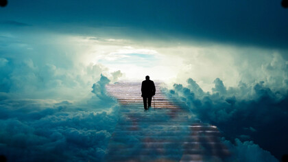 An older gentleman walks up the stairs to the sky