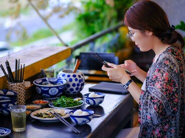 A food traveler documenting a regional meal before dining, reflecting the excitement of discovering local cuisine