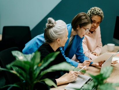 Co-workers brainstorming together in a collaborative environment, representing how ownership encourages long-term commitment