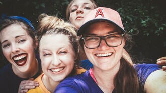 A group of friends in good spirits and expressing their happiness