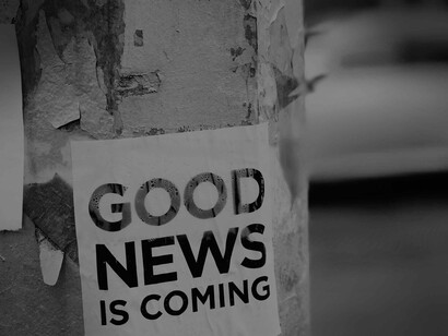 A sign on a street lampost gives us the unreliable hope that 'good news is coming' is a tongue in cheek way of saying that there is no such thing in the media 