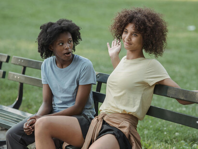 Two women having a conversation on a park