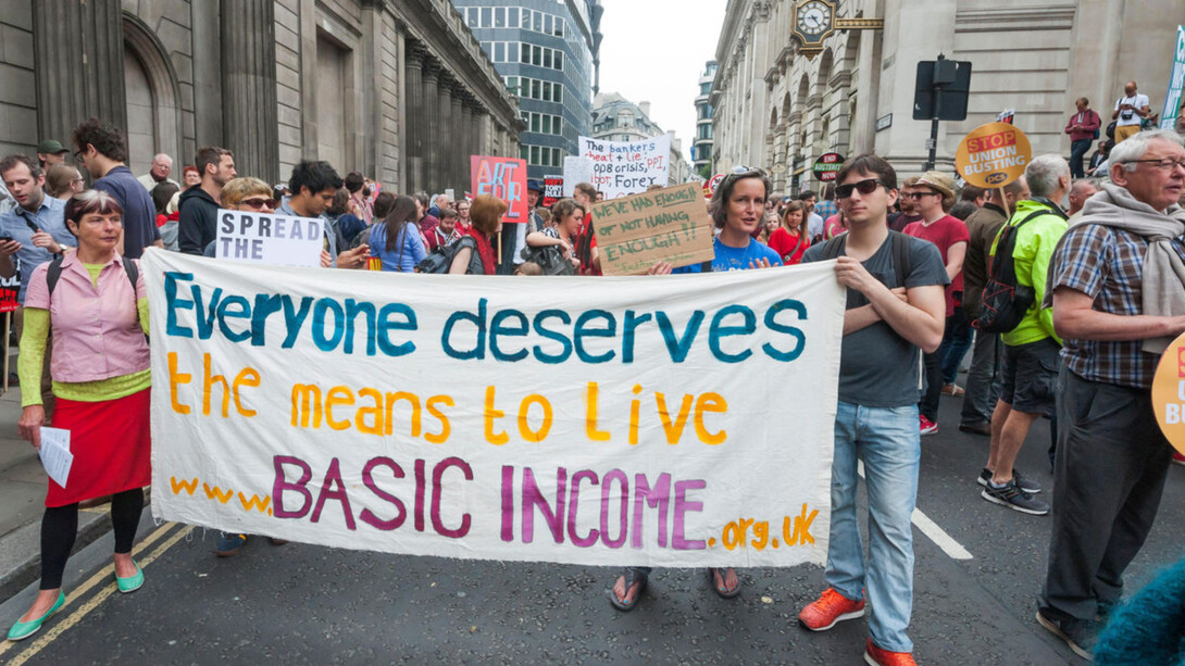 Protesters march for the basic income initiative