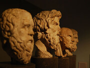 A photo of four philosophical busts, featuring Aristotle and other great thinkers, capturing the essence of timeless wisdom