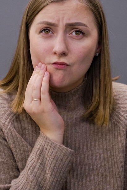 Woman experiencing discomfort from ulcer