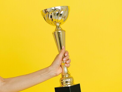 Person celebrating with a trophy