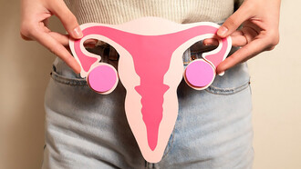 Front view woman holding woman reproductive system cardboard