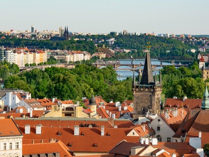 A view of Prague with its rooftops, bridges, churches, and river, reflecting the city’s connection between architecture, history, and discovery