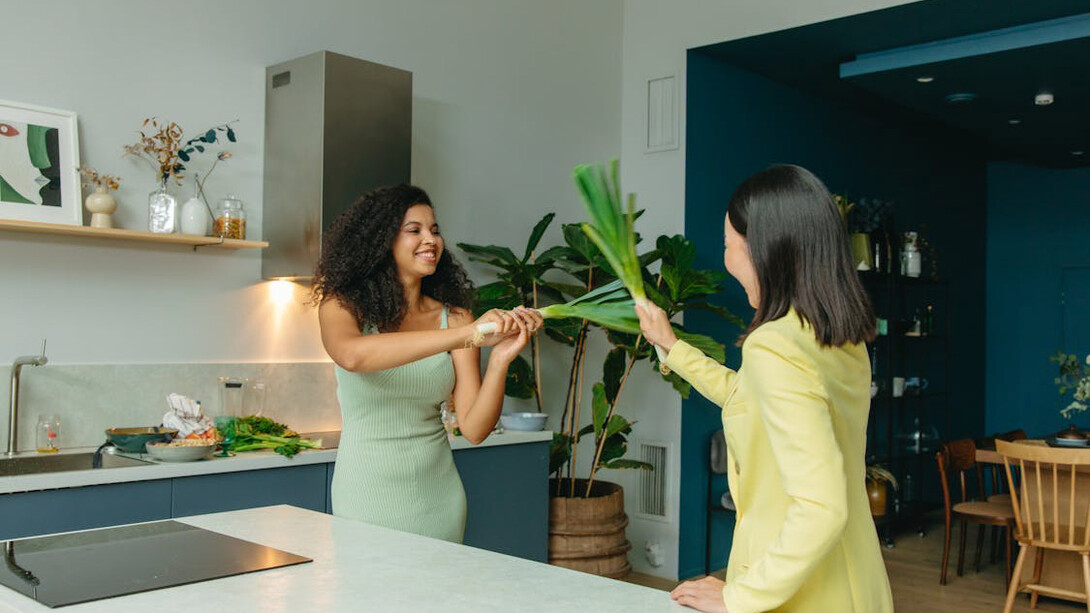 A lively kitchen scene captures the essence of health as two friends supplement their day with omega-3s from natural sources