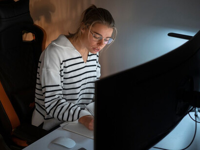 A woman working late at night, exploring Blockchain technology, decentralized AI, and AI agents on the Avalanche blockchain within the Web3 ecosystem