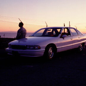 Jason Rhoades with the Caprice overlooking Los Angeles International Airport, 1996. © The Estate of Jason Rhoades. Courtesy the Estate of Jason Rhoades and Hauser & Wirth