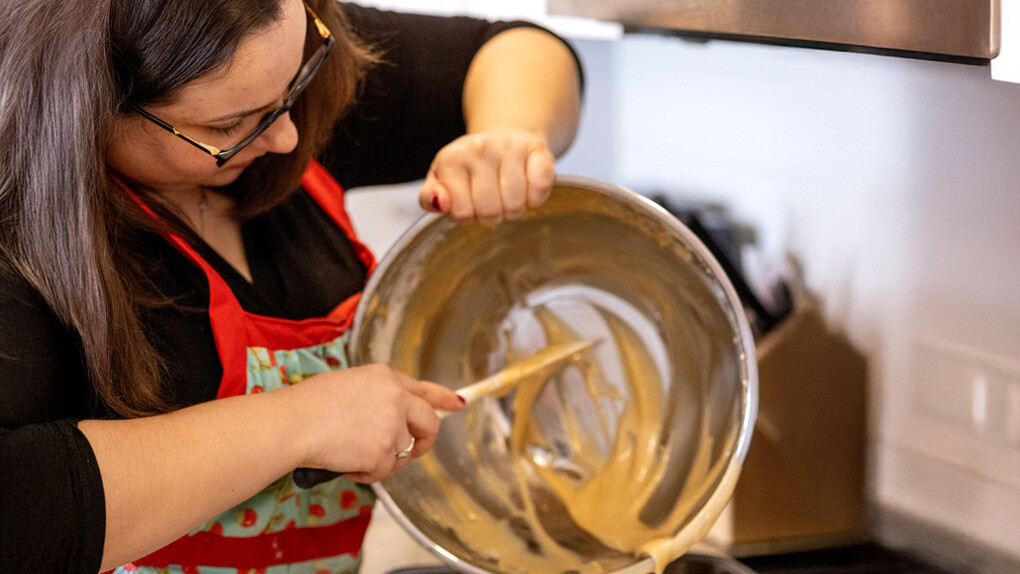 Andrea pours the batter for honey cake, a Jewish New Year tradition. Courtesy of Ingenium. The Canada Agriculture and Food Museum. Photo by Lisa Milosavljevic