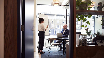 Sharing ideas and goals, a woman demonstrates the synergy between trusted allies in the professional world