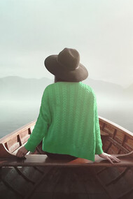 A woman in nature, seated on a boat, embodying the journey to self, mindfulness, and the freedom of life beyond professional roles