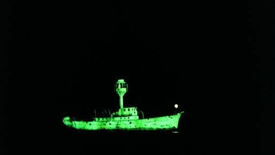 Dorothy Cross, Ghost Ship, 1999 , Two light ship models, phosphorescent paint and u.v.lights, video, 10 minute loop, Collection Irish Museum of Modern Art, Purchase, 2003
