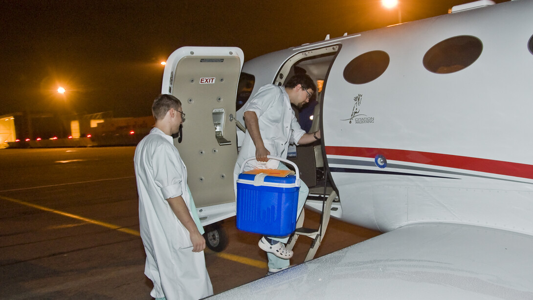 Organ transport team preparing to board an airplane