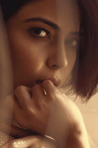 Her tender touch against her face reflects the understanding that true pleasure often begins within, extending beyond mere physical sensations