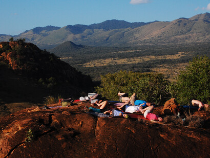 Yoga retreat goers from Modo Yoga on top of a look out hill at Campi ya Kanzi 