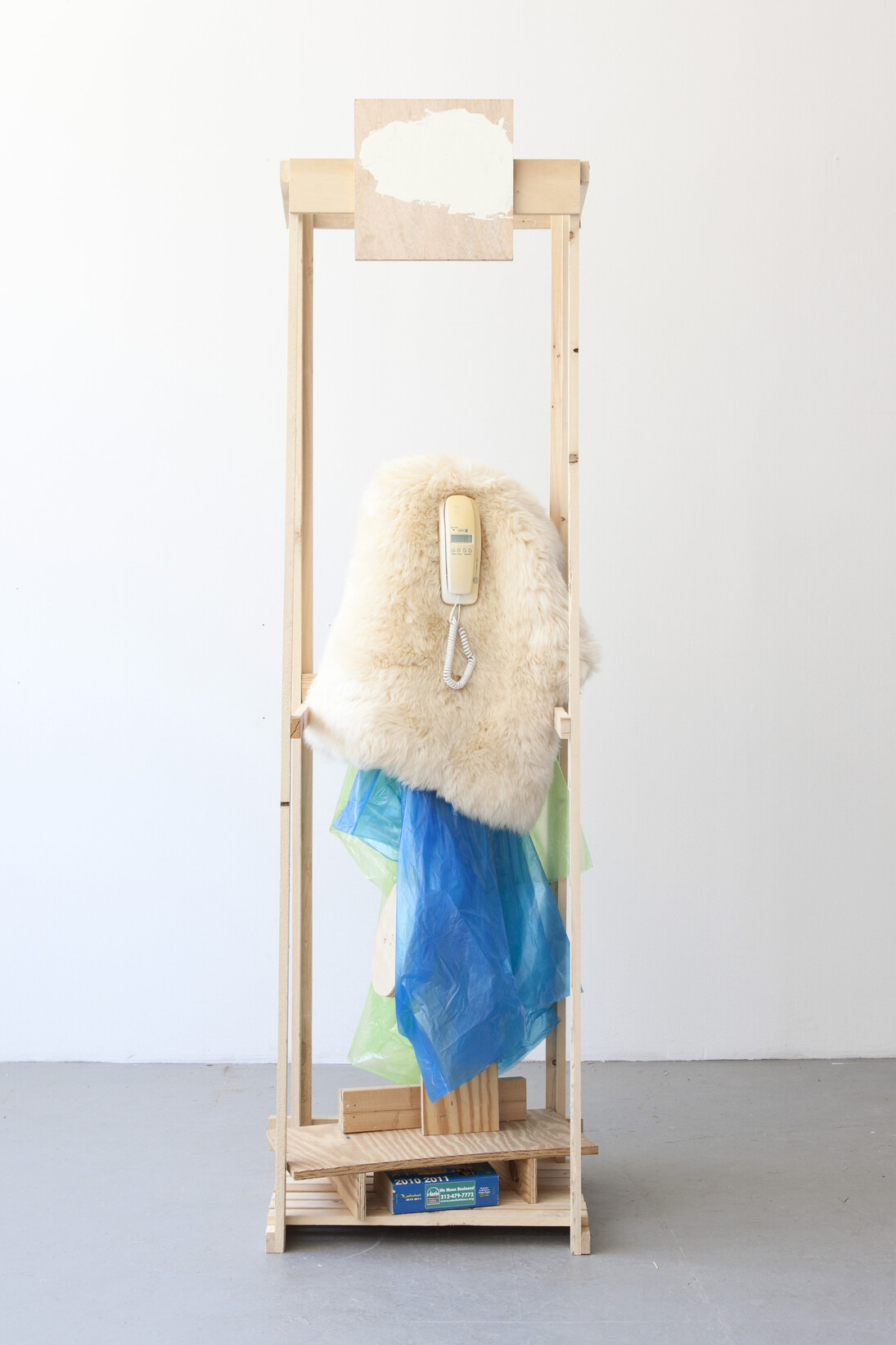Rachel Harrison, Caller ID, 2014, Wood, plastic, fake fur, telephone book, and telephone book, 88 1/4 x 27 1/2 x 19 3/4 inches (224.2 x 69.9 x 50.2 cm). Courtesy the artist and Greene Naftali Gallery