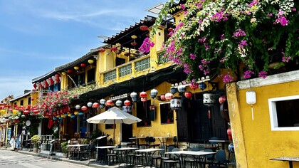 Yellow façades and cascading bougainvillea along Hoi An’s old town streets in Vietnam  ©Alma Reyes