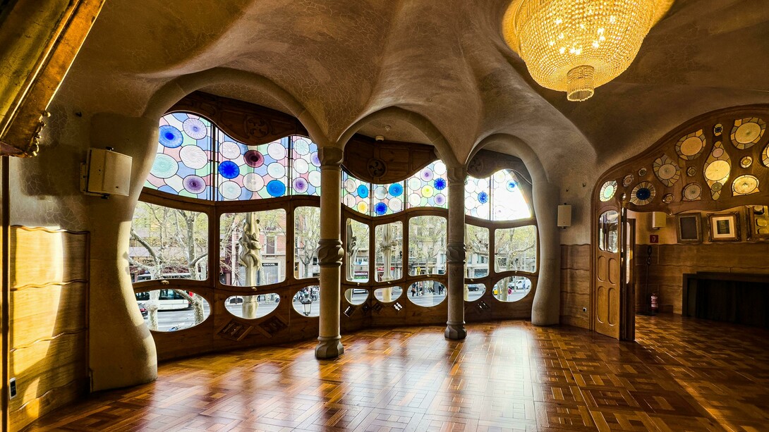 Barcelona, Spain, the interior of Casa Batlló featuring a decorative ceiling and large windows, showcasing Antoni Gaudí’s distinctive design style