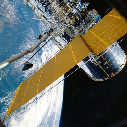 Satellite view of Earth featuring a white orbital satellite, highlighting modern space technology and the perspective of Earth as seen from the ISS