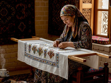 An Uzbek master craftswoman carefully creates a suzani-style tablecloth, keeping the ancient tradition of hand embroidery alive