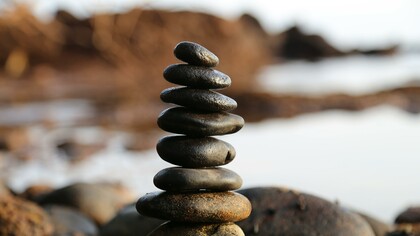 Pile of rocks next to a lake 