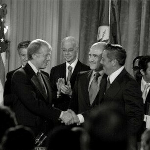 Then President Jimmy Carter and General Omar Torrijos shake hands moments after the signing of the Torrijos–Carter Treaties