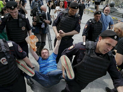 A gay rights activist is seen being detained by police during an LGBT community rally in Moscow in 2015