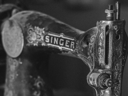 The intricate details of this antique sewing machine highlight a key historical moment where mechanical technology significantly transformed the speed and accessibility of clothing creation