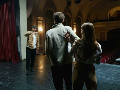 People preparing for a play on the theatre stage